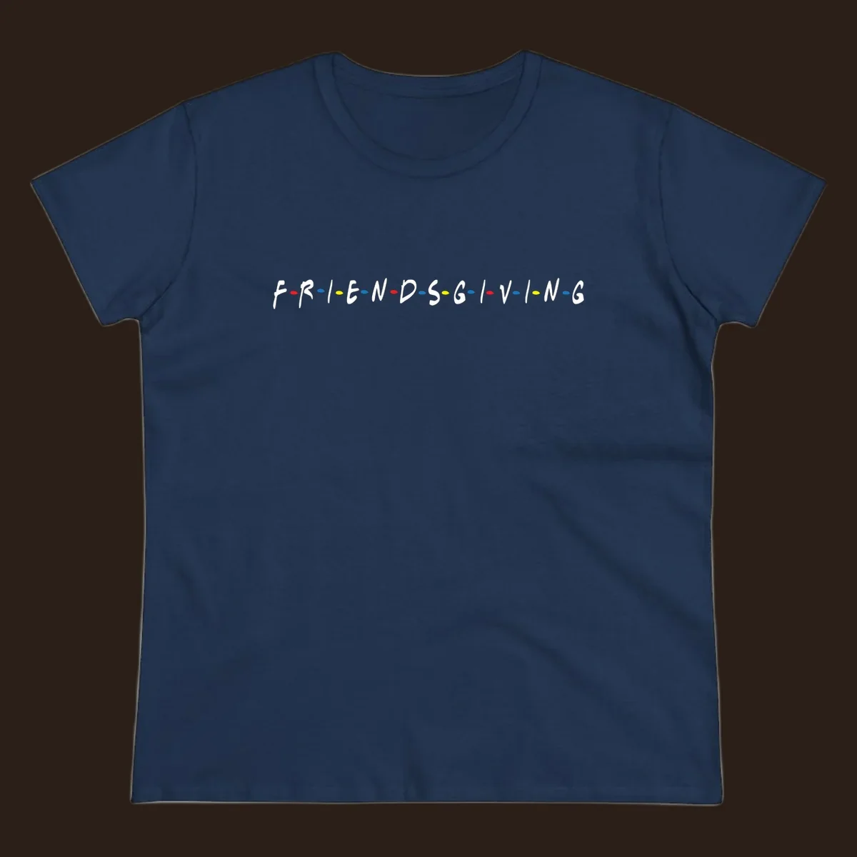 Friendsgiving typography design with white letters and colored dots on a black background.