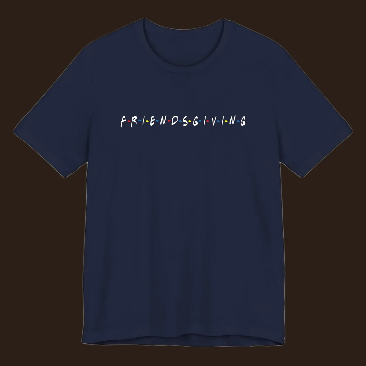 Friendsgiving typography design with white letters and colored dots on a black background.