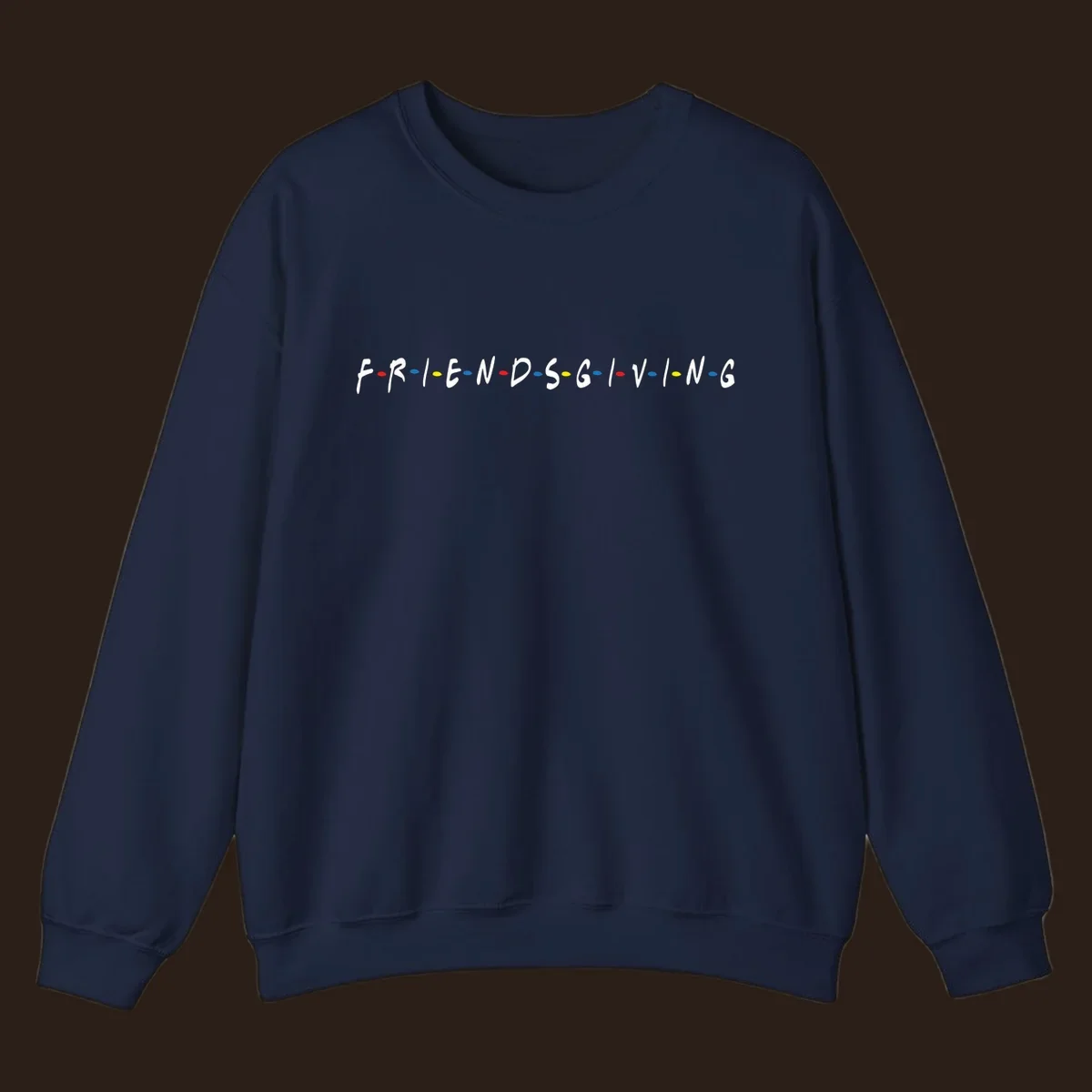 Friendsgiving typography design with white letters and colored dots on a black background.