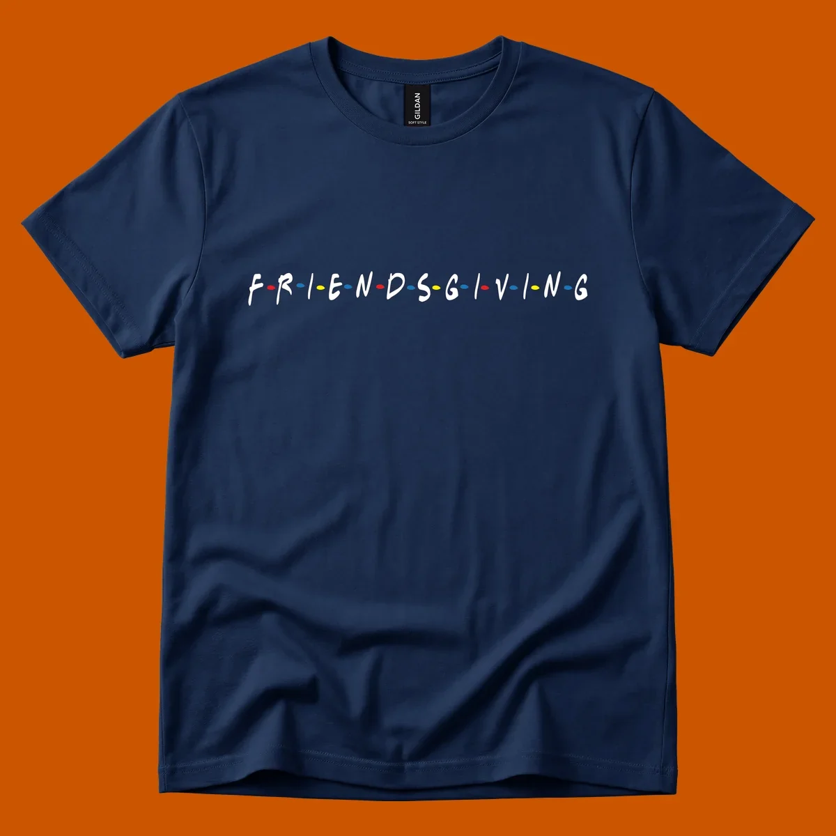 Friendsgiving typography design with white letters and colored dots on a black background.