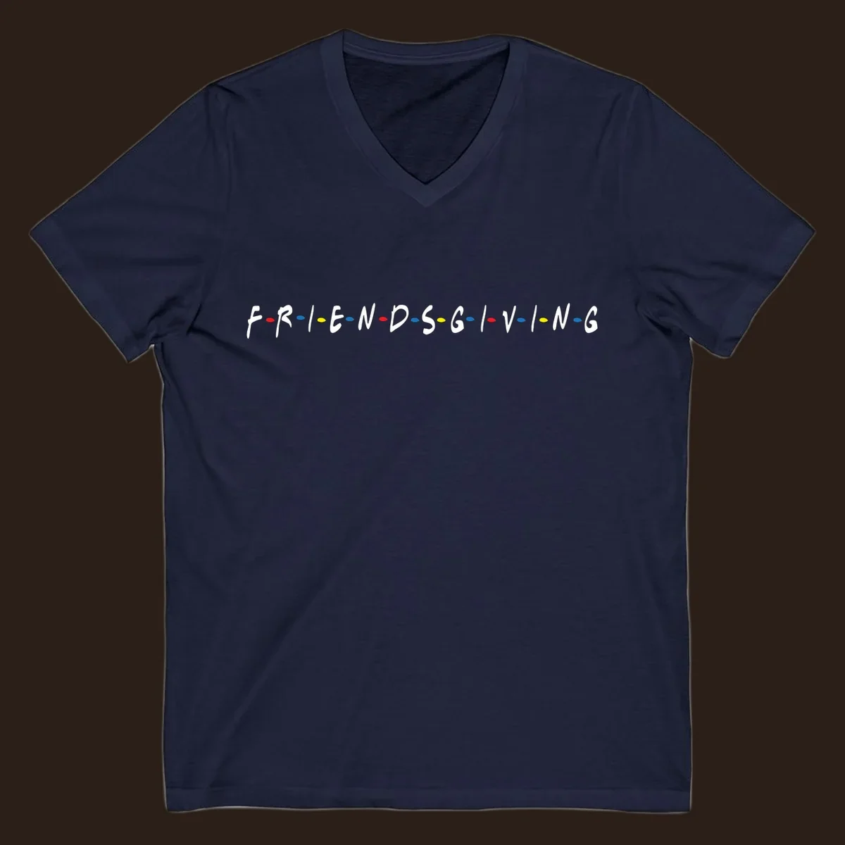 Friendsgiving typography design with white letters and colored dots on a black background.