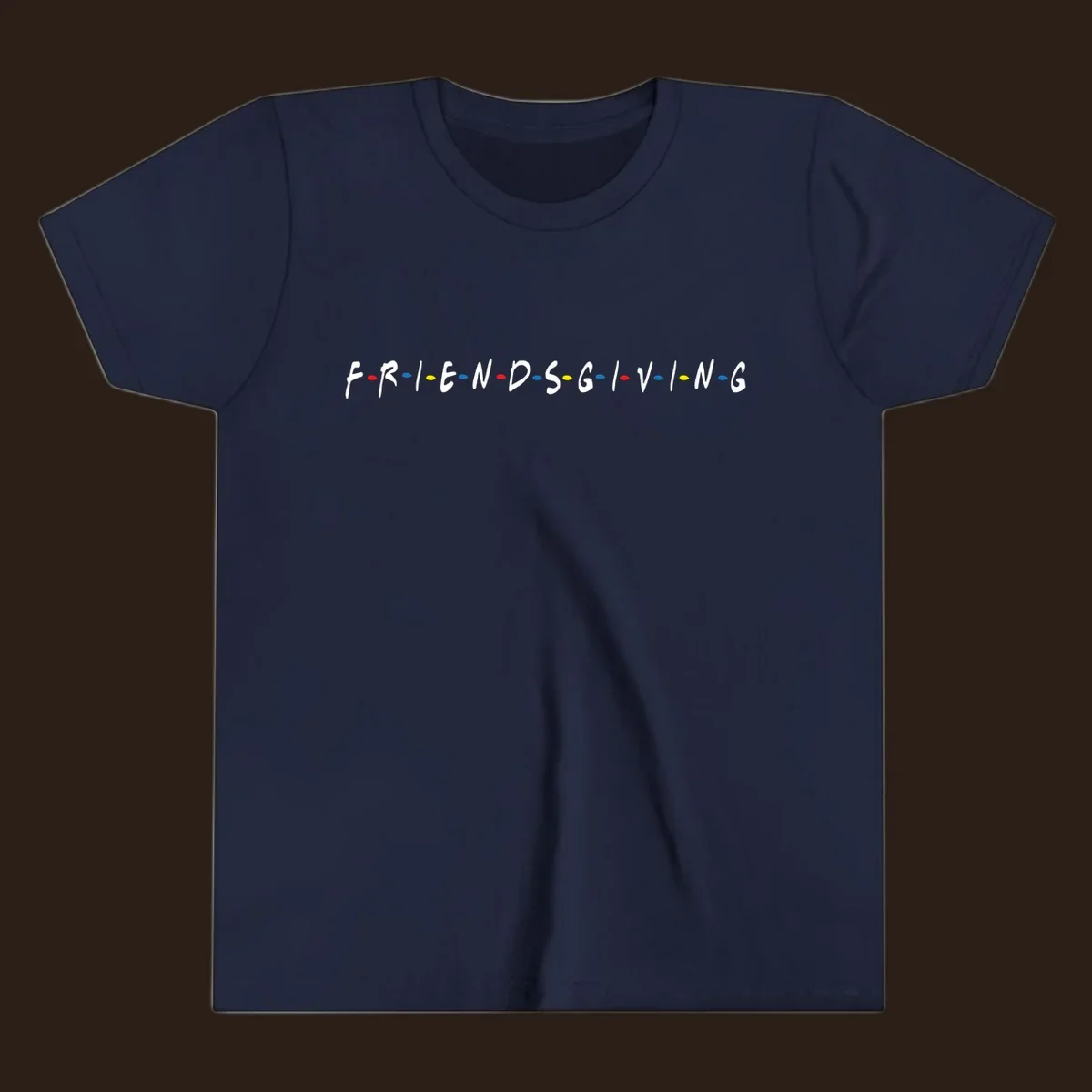 Friendsgiving typography design with white letters and colored dots on a black background.