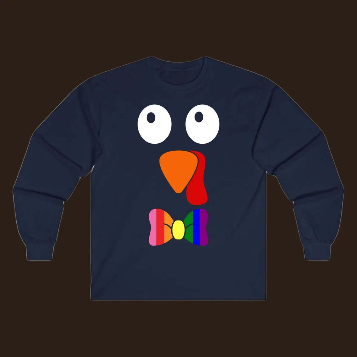 Cartoon turkey face with rainbow bowtie, featuring large eyes, orange beak, and red wattle. Thanksgiving holiday graphic.