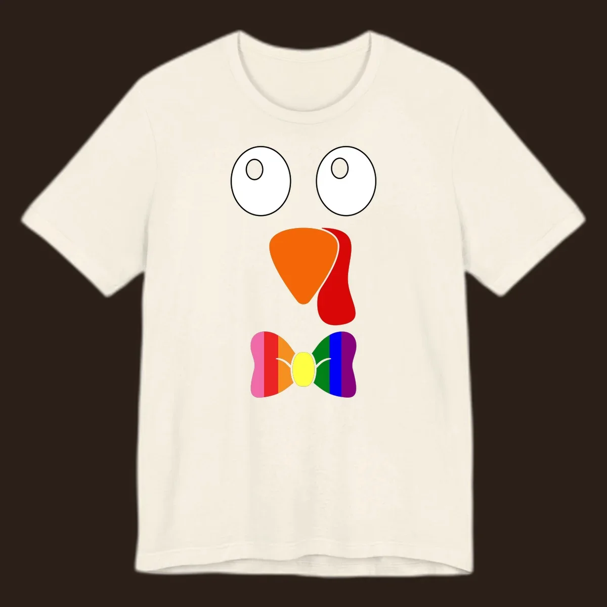 Cartoon turkey face with rainbow bowtie, featuring large eyes, orange beak, and red wattle. Thanksgiving holiday graphic.