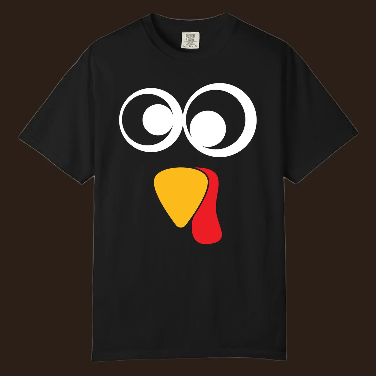 Googly-eyed turkey face illustration with yellow beak and red wattle.