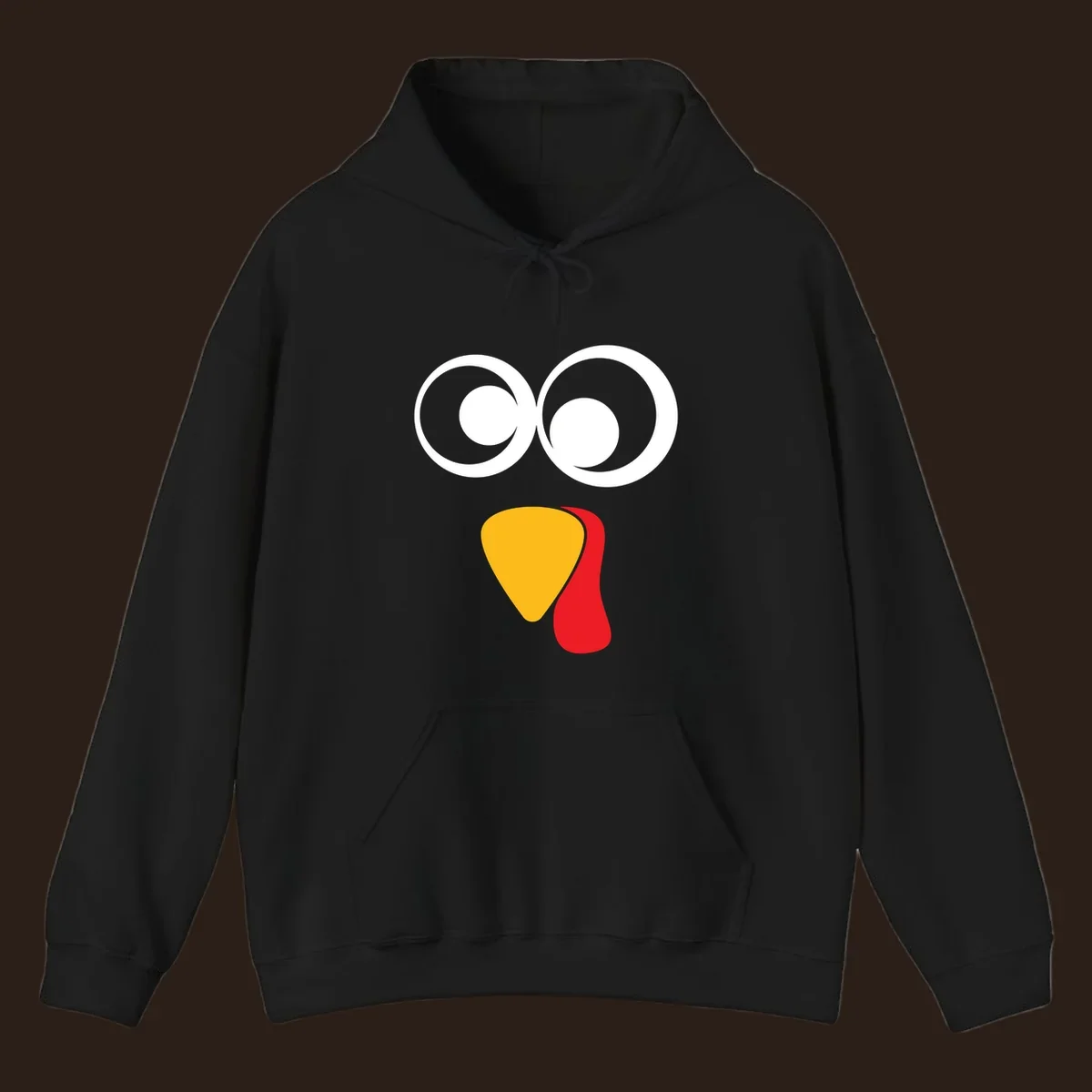 Googly-eyed turkey face illustration with yellow beak and red wattle.