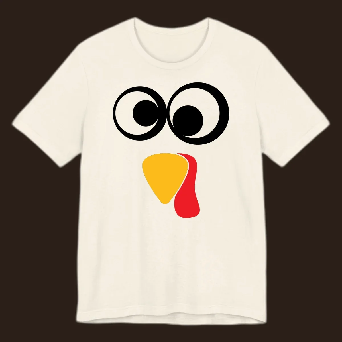 Googly-eyed turkey face illustration with yellow beak and red wattle.