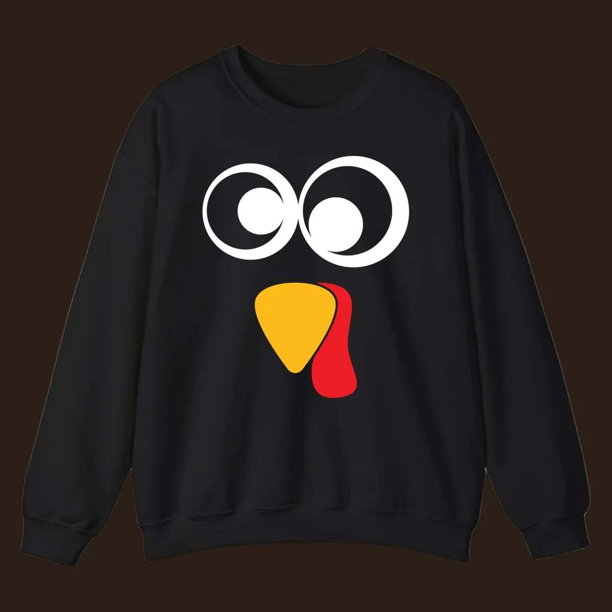 Googly-eyed turkey face illustration with yellow beak and red wattle.