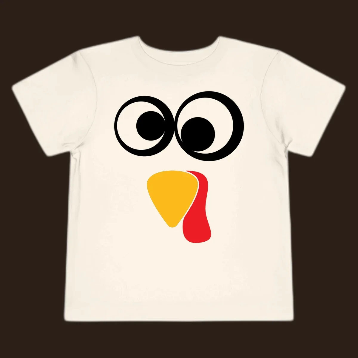 Googly-eyed turkey face illustration with yellow beak and red wattle.