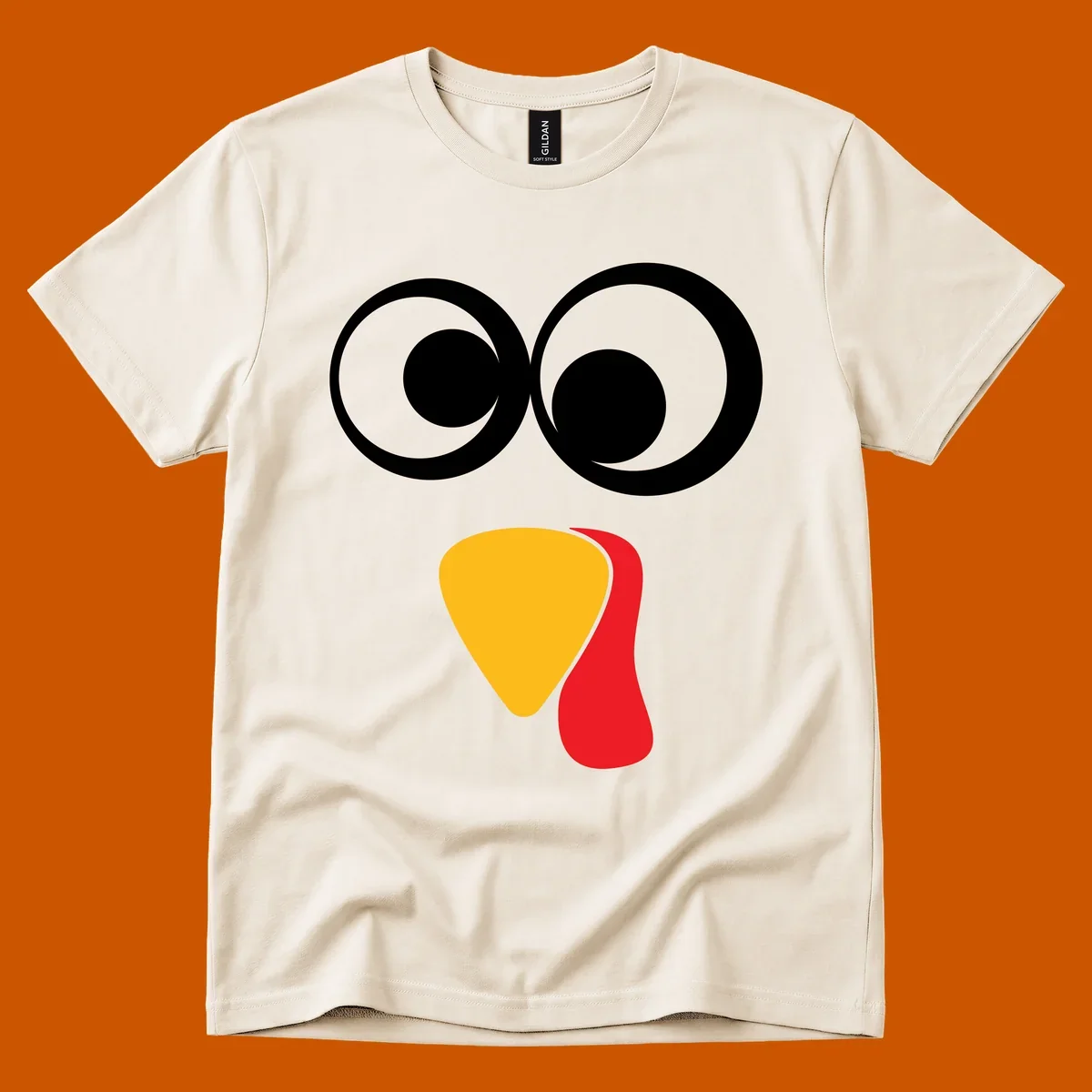 Googly-eyed turkey face illustration with yellow beak and red wattle.