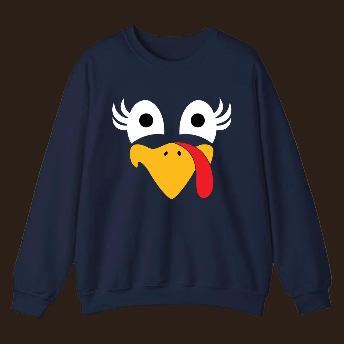 Funny turkey face illustration with googly eyes and a red wattle, for Thanksgiving.
