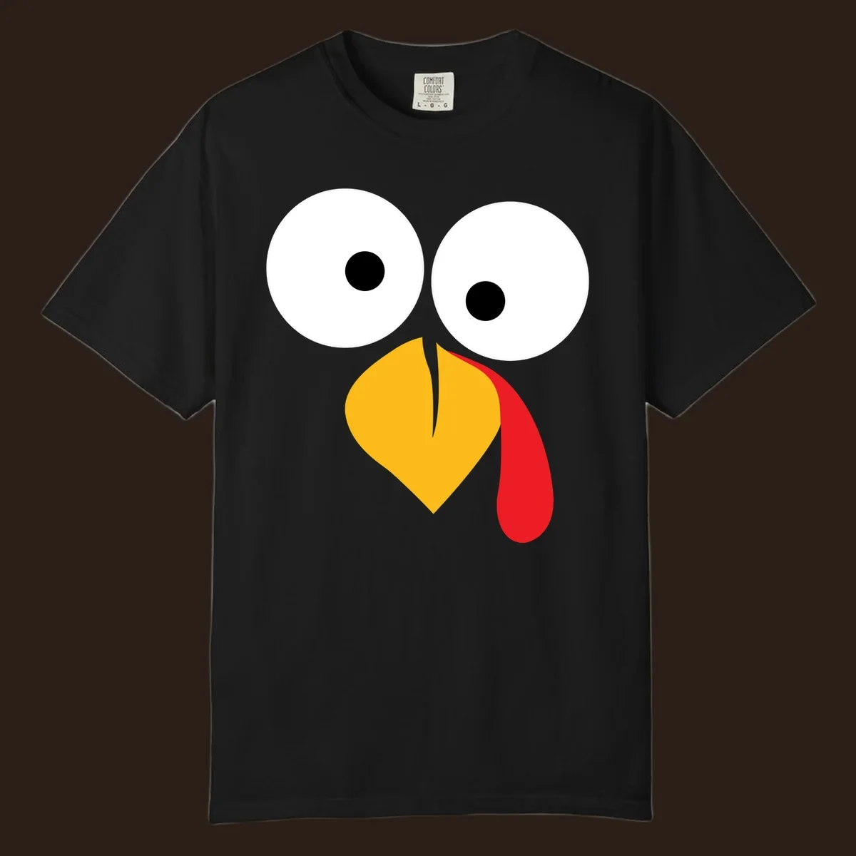 Googly-eyed turkey face illustration with yellow beak and red wattle.