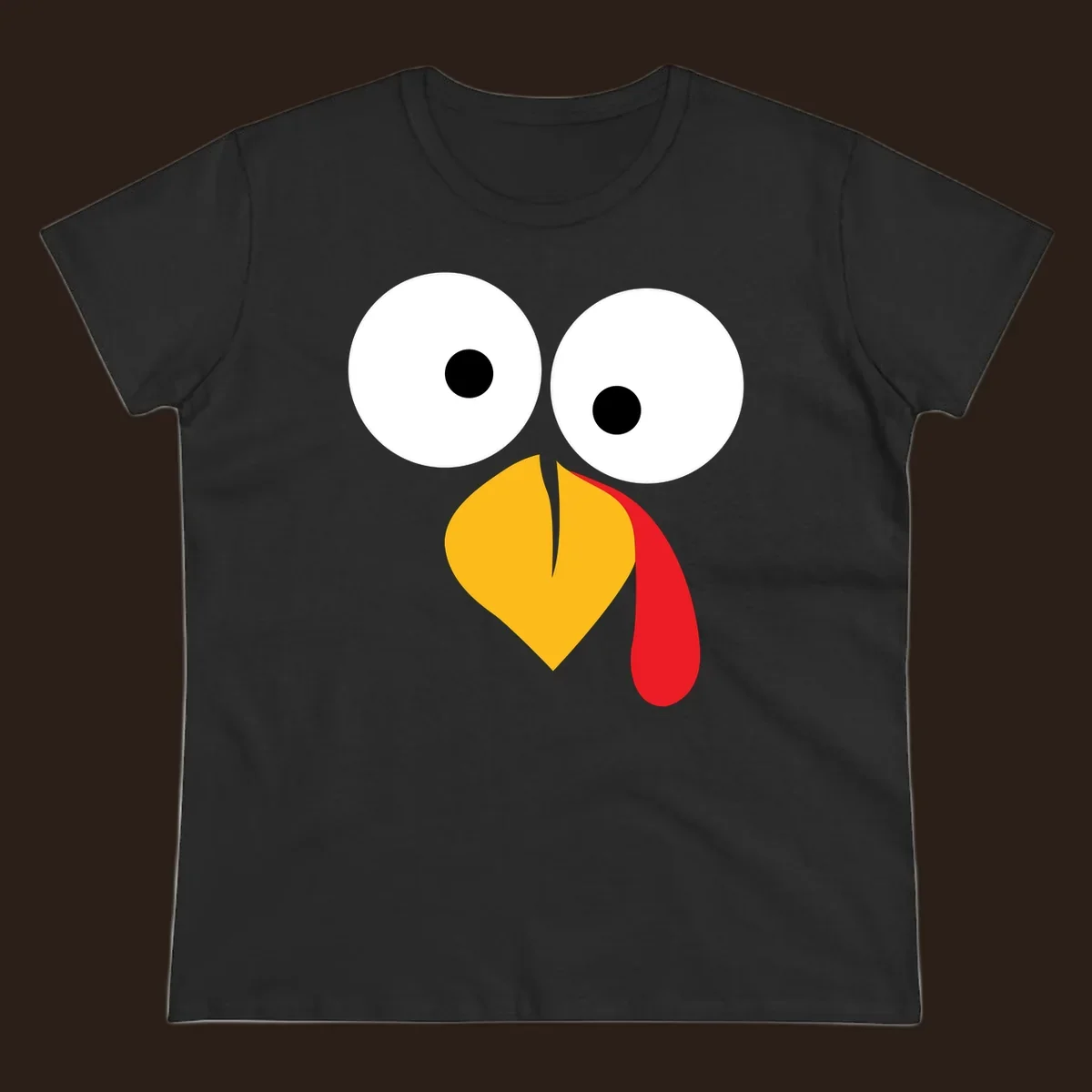 Googly-eyed turkey face illustration with yellow beak and red wattle.