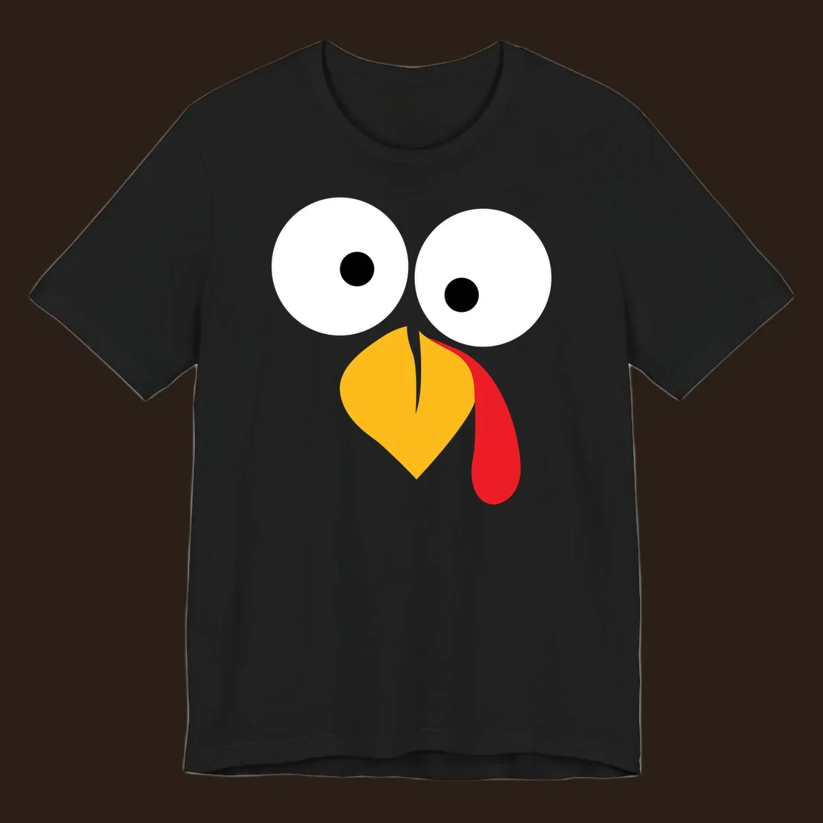 Googly-eyed turkey face illustration with yellow beak and red wattle.
