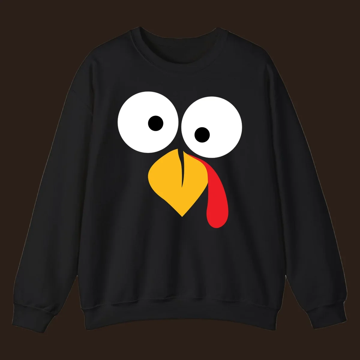 Googly-eyed turkey face illustration with yellow beak and red wattle.