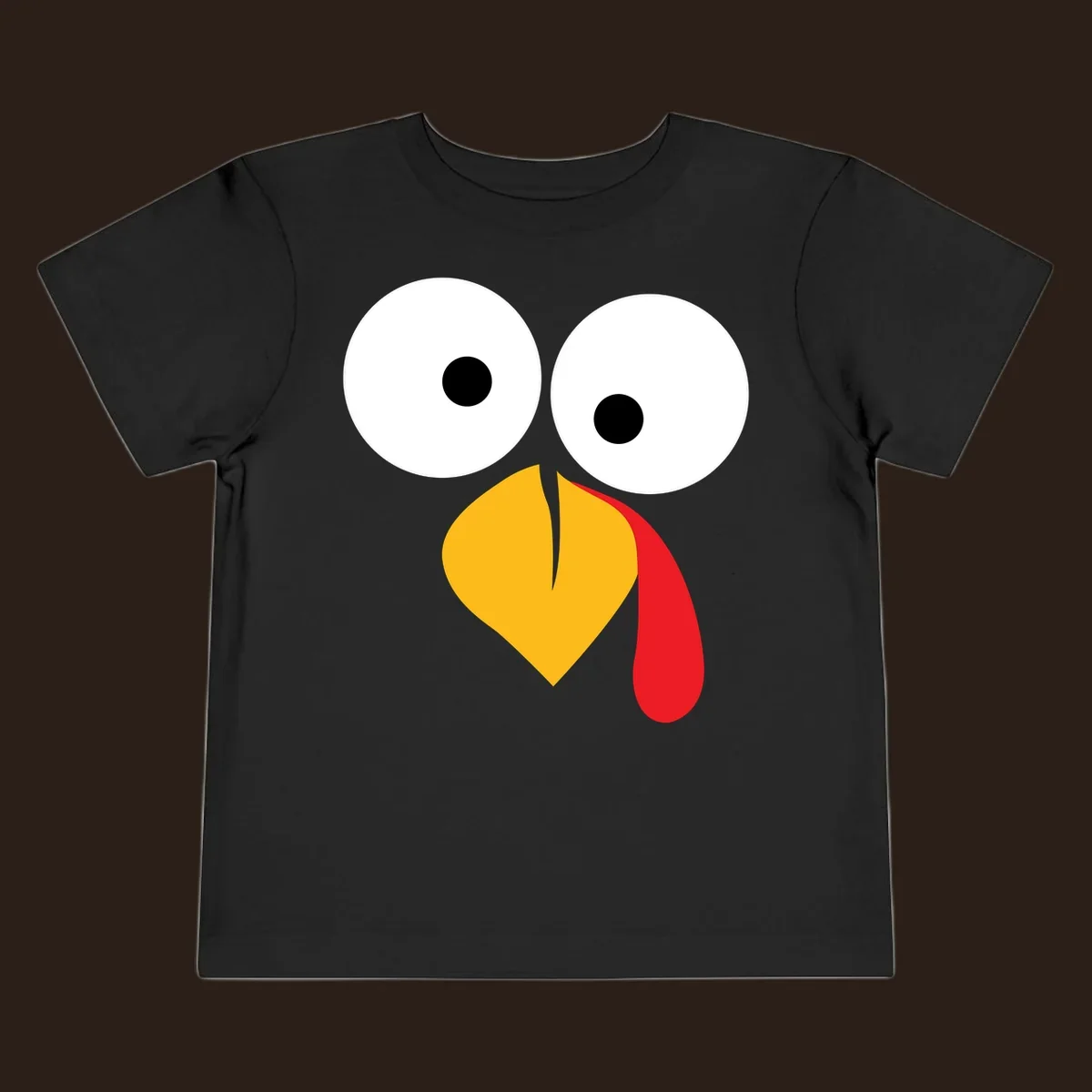 Googly-eyed turkey face illustration with yellow beak and red wattle.