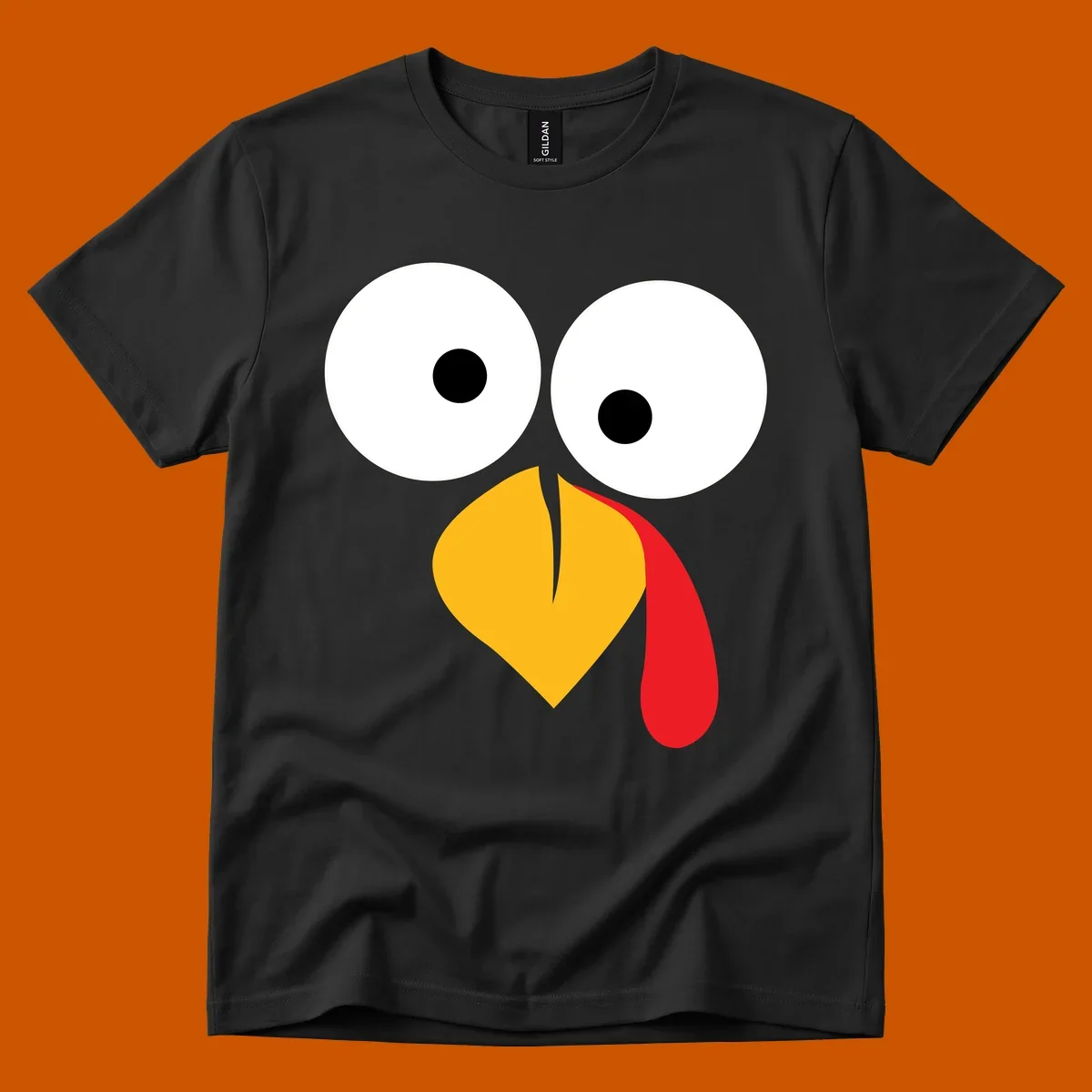 Googly-eyed turkey face illustration with yellow beak and red wattle.