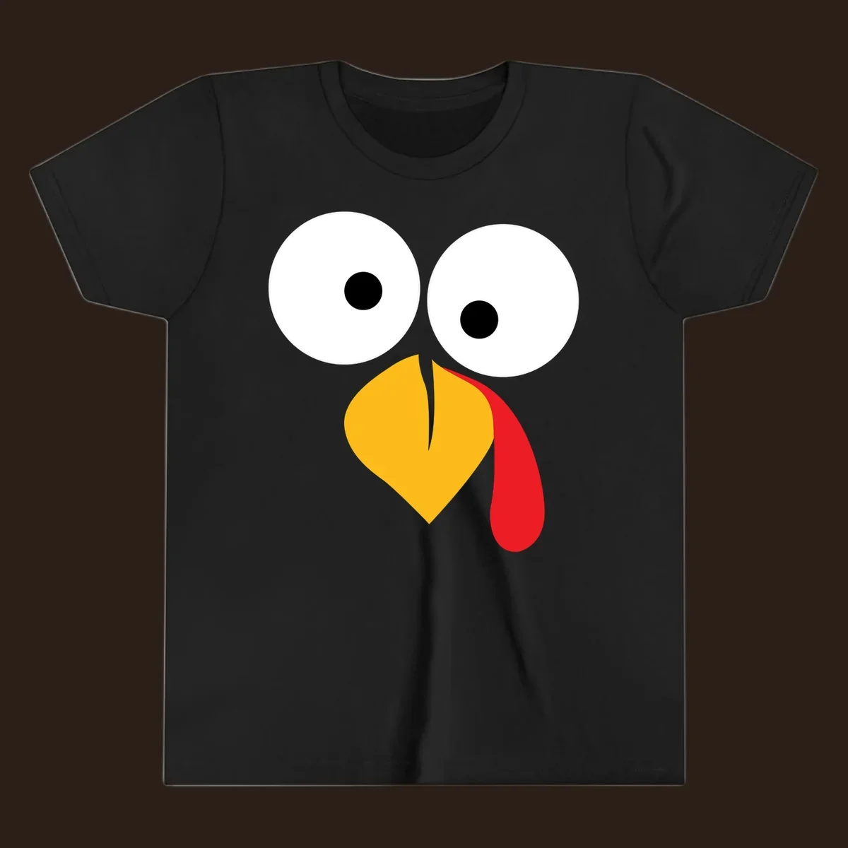 Googly-eyed turkey face illustration with yellow beak and red wattle.