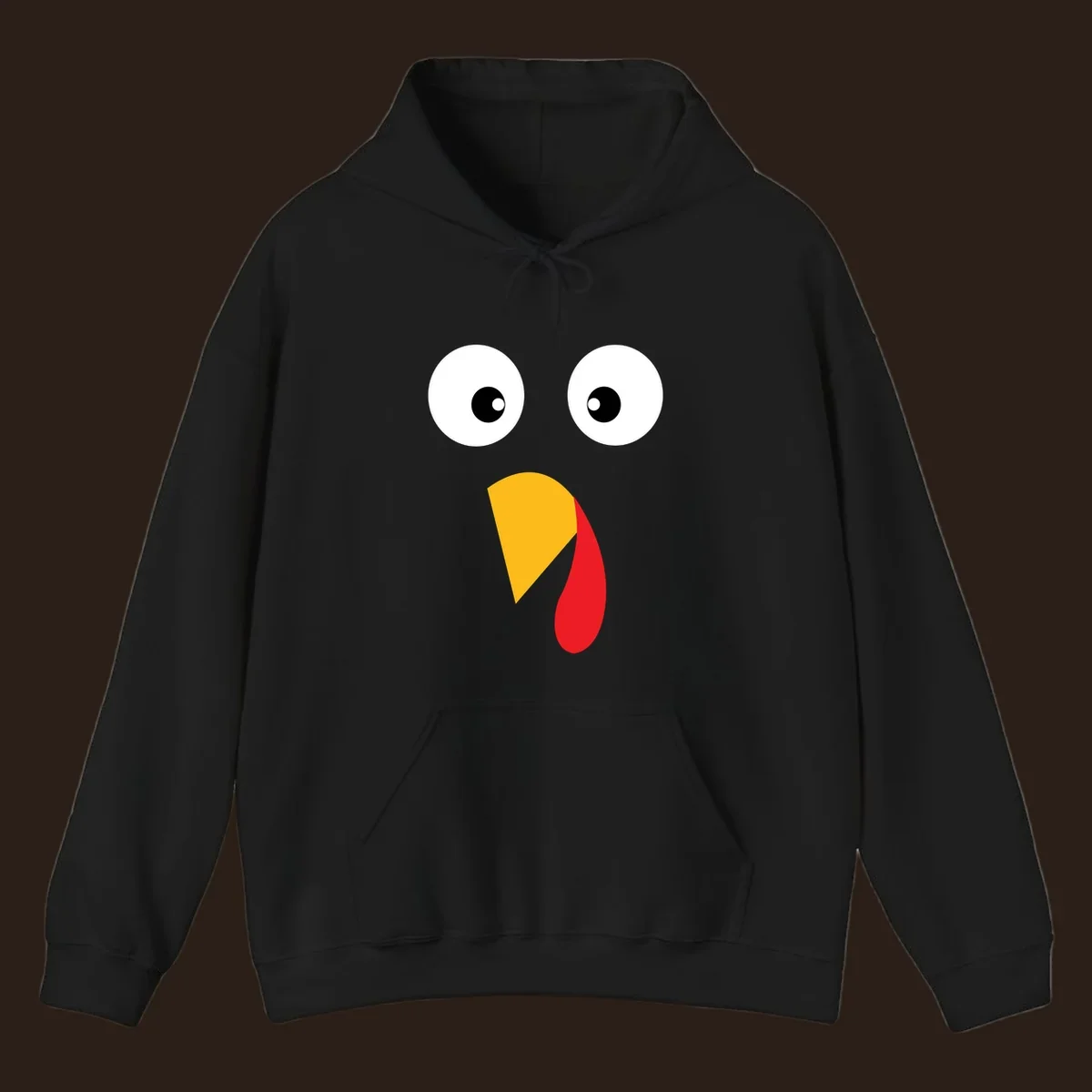 Googly eyed turkey face illustration with yellow beak and red wattle on black background.