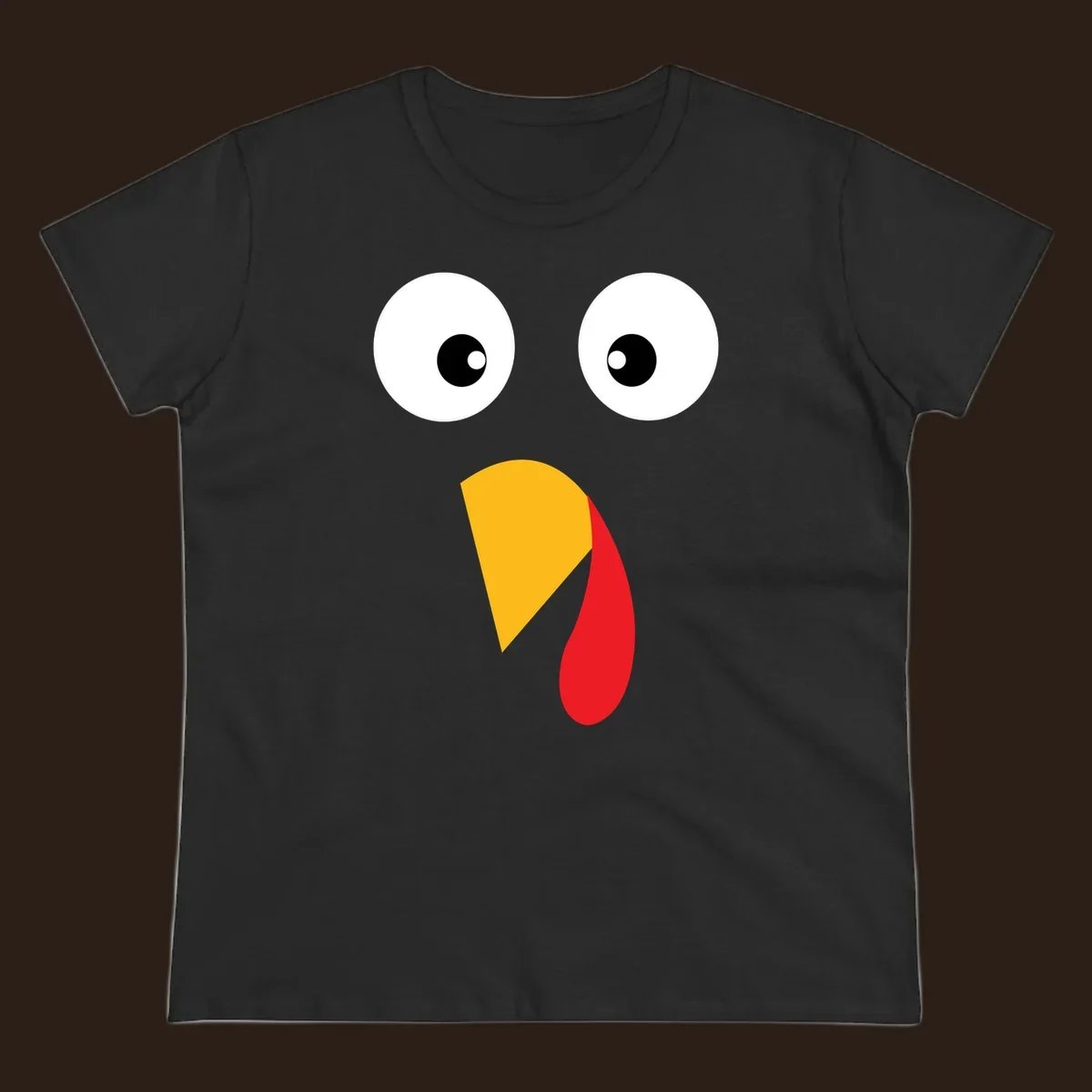 Googly eyed turkey face illustration with yellow beak and red wattle on black background.