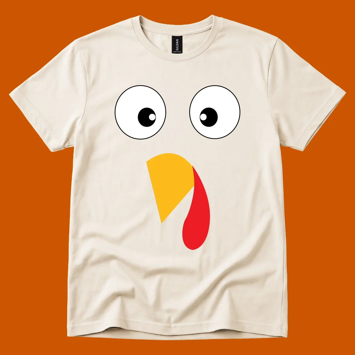Googly eyed turkey face illustration with yellow beak and red wattle on black background.