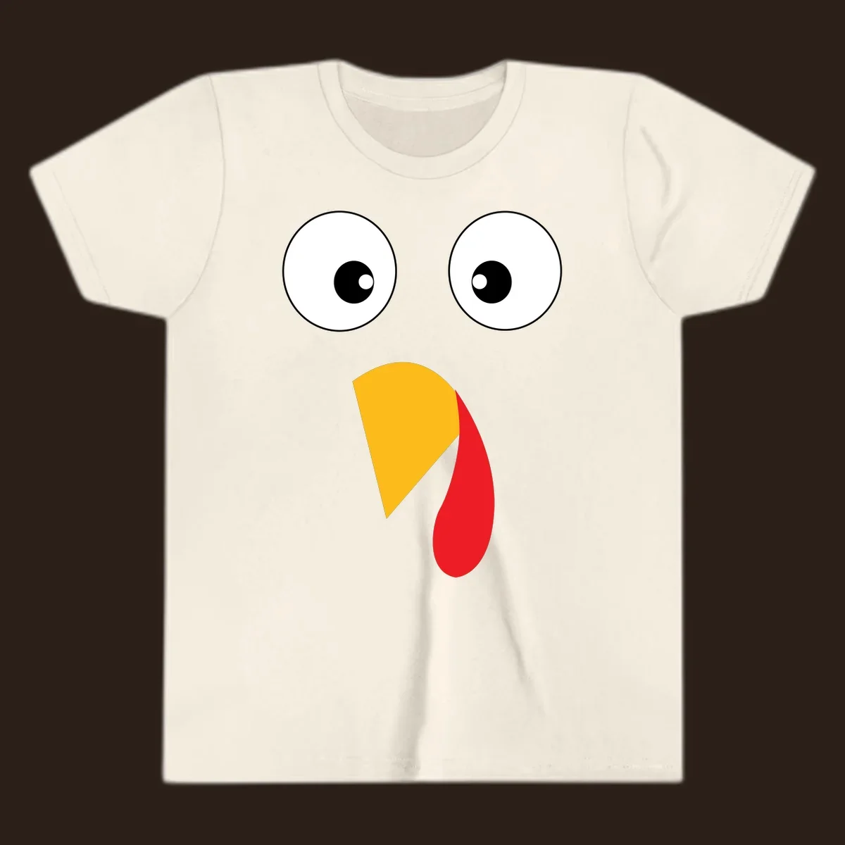 Googly eyed turkey face illustration with yellow beak and red wattle on black background.