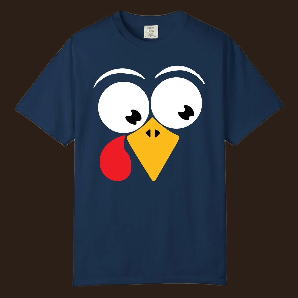 Googly eyed turkey face with yellow beak and red wattle on black background.