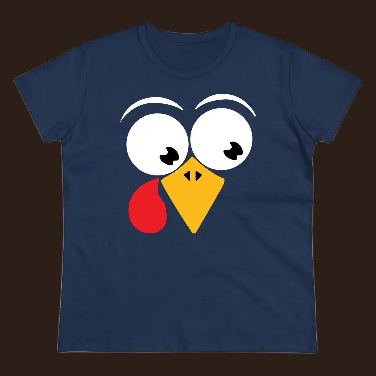 Googly eyed turkey face with yellow beak and red wattle on black background.