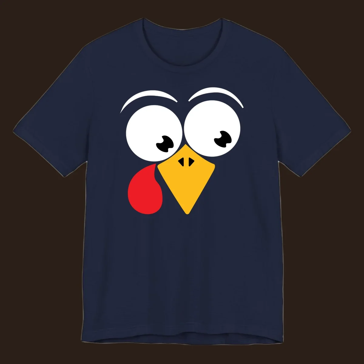 Googly eyed turkey face with yellow beak and red wattle on black background.