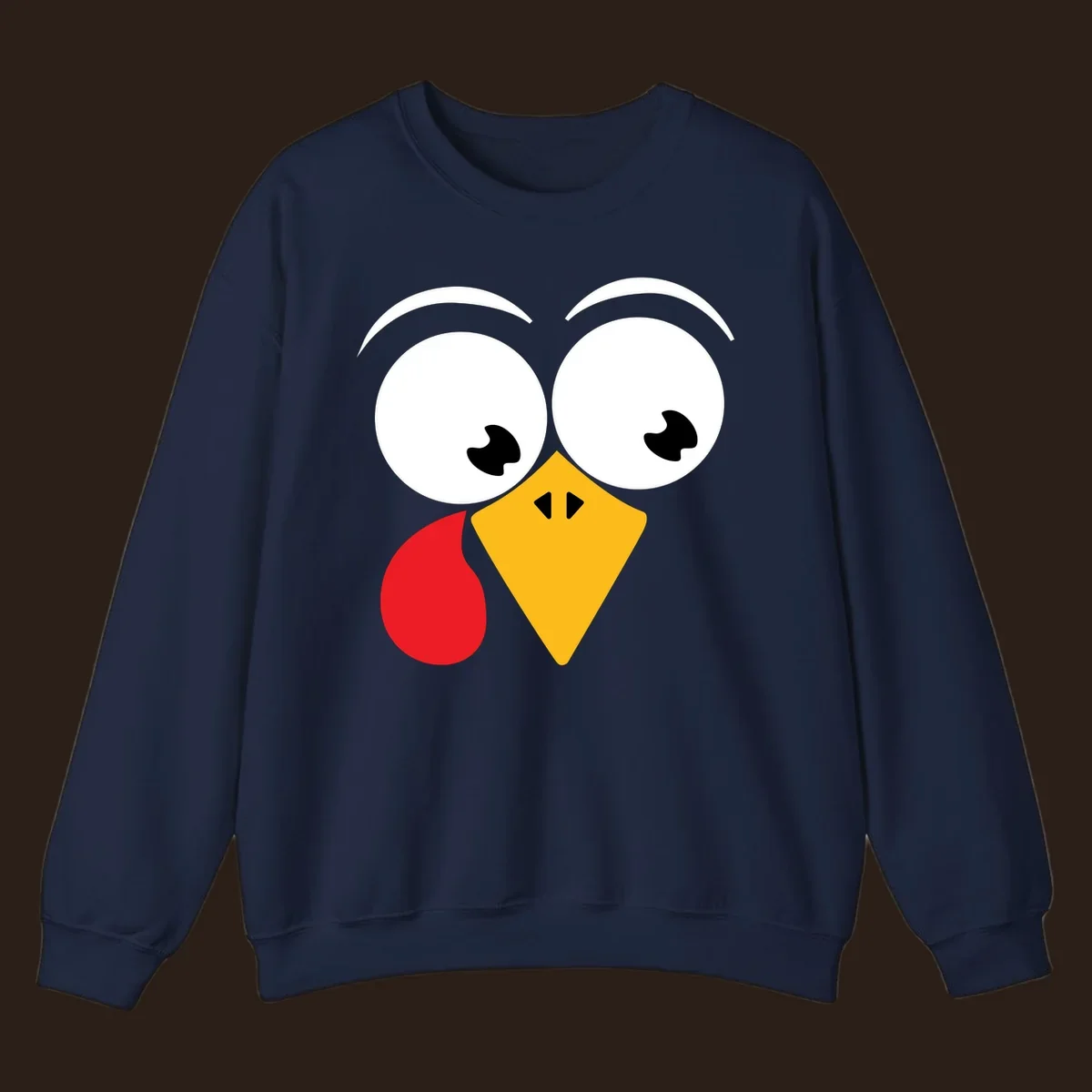 Googly eyed turkey face with yellow beak and red wattle on black background.