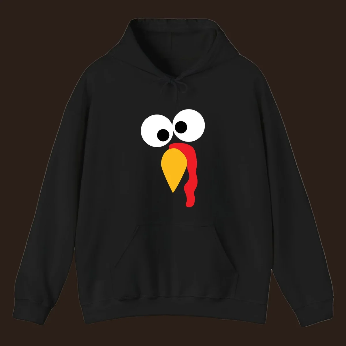 Googly-eyed turkey face illustration with yellow beak and red wattle.