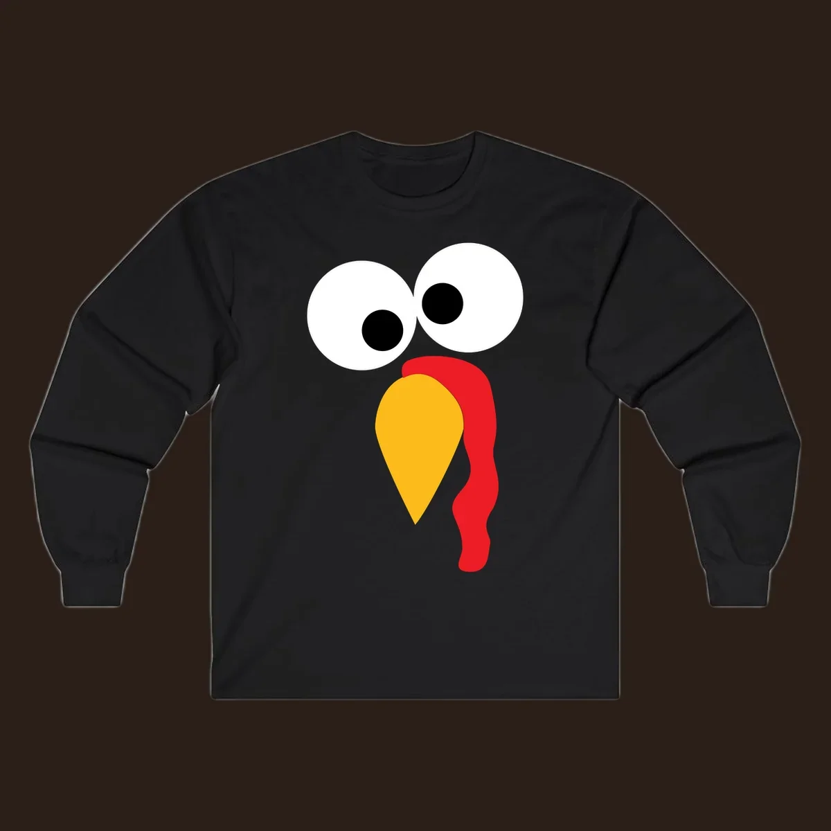 Googly-eyed turkey face illustration with yellow beak and red wattle.