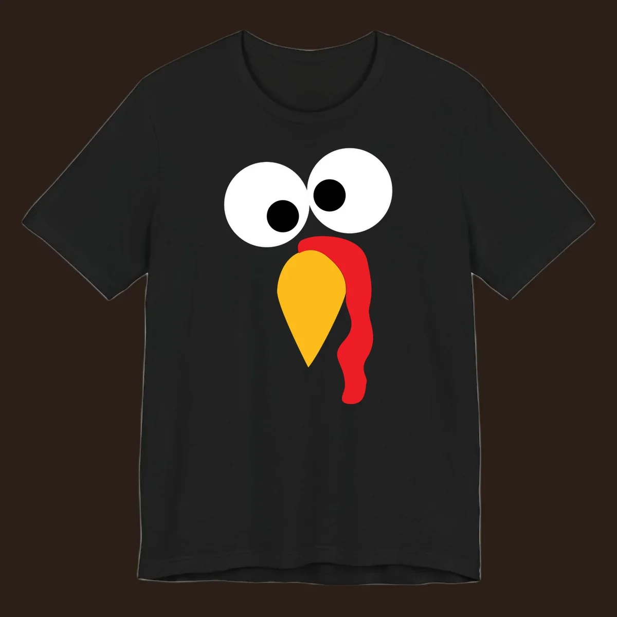 Googly-eyed turkey face illustration with yellow beak and red wattle.