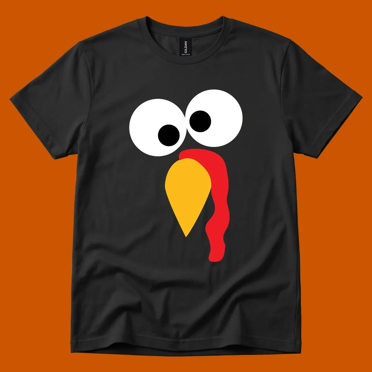 Googly-eyed turkey face illustration with yellow beak and red wattle.