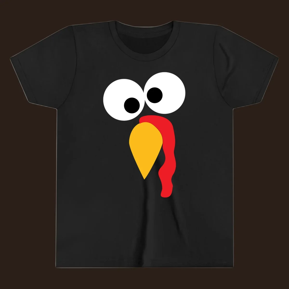 Googly-eyed turkey face illustration with yellow beak and red wattle.