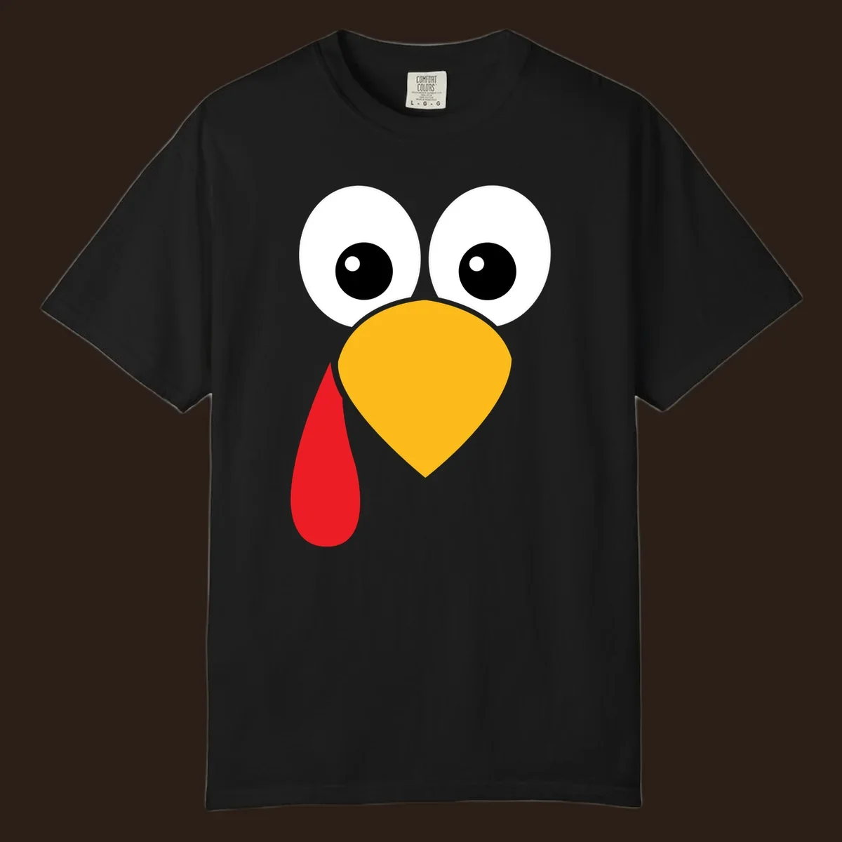 Funny turkey face illustration with big eyes, yellow beak, and red wattle for Thanksgiving.