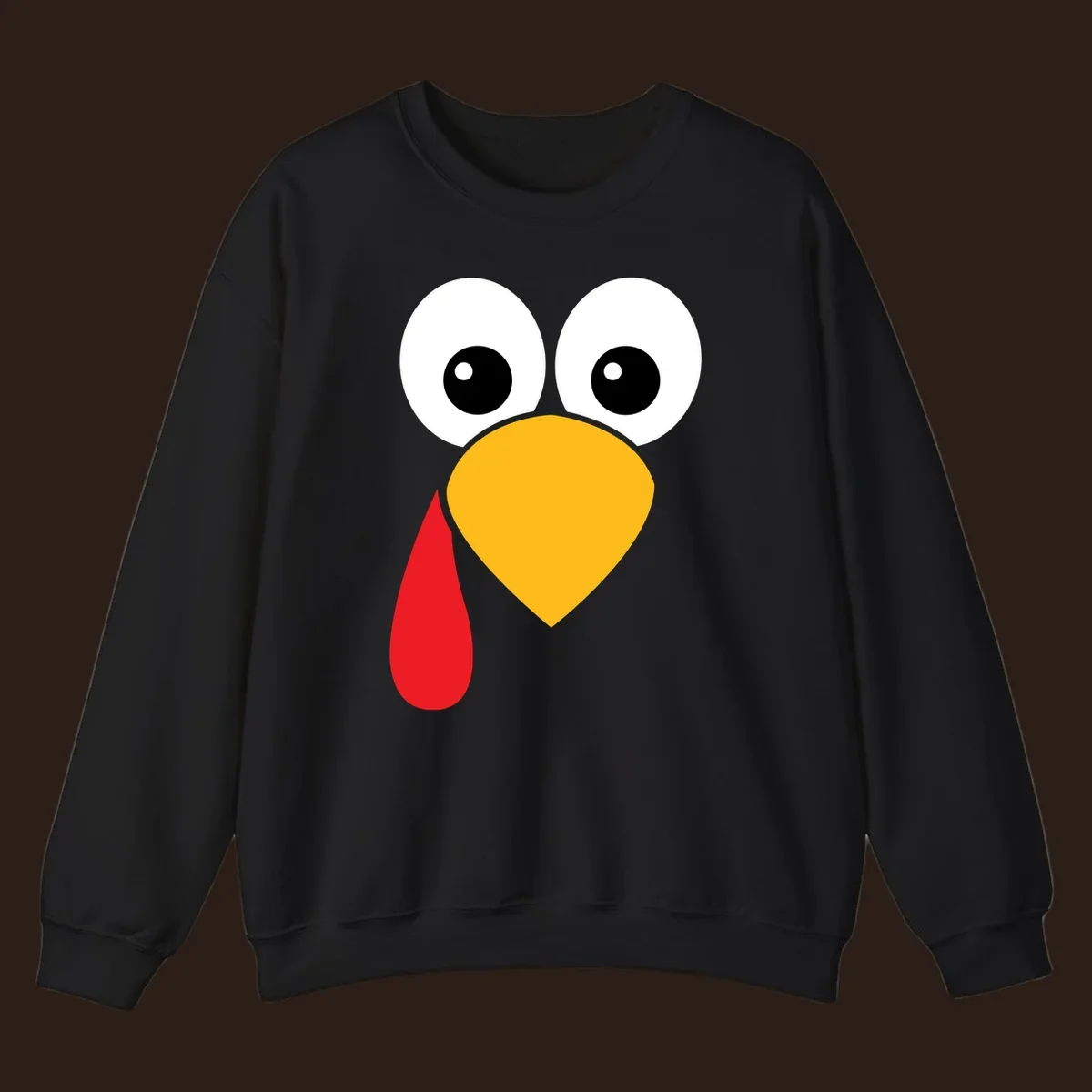 Funny turkey face illustration with big eyes, yellow beak, and red wattle for Thanksgiving.
