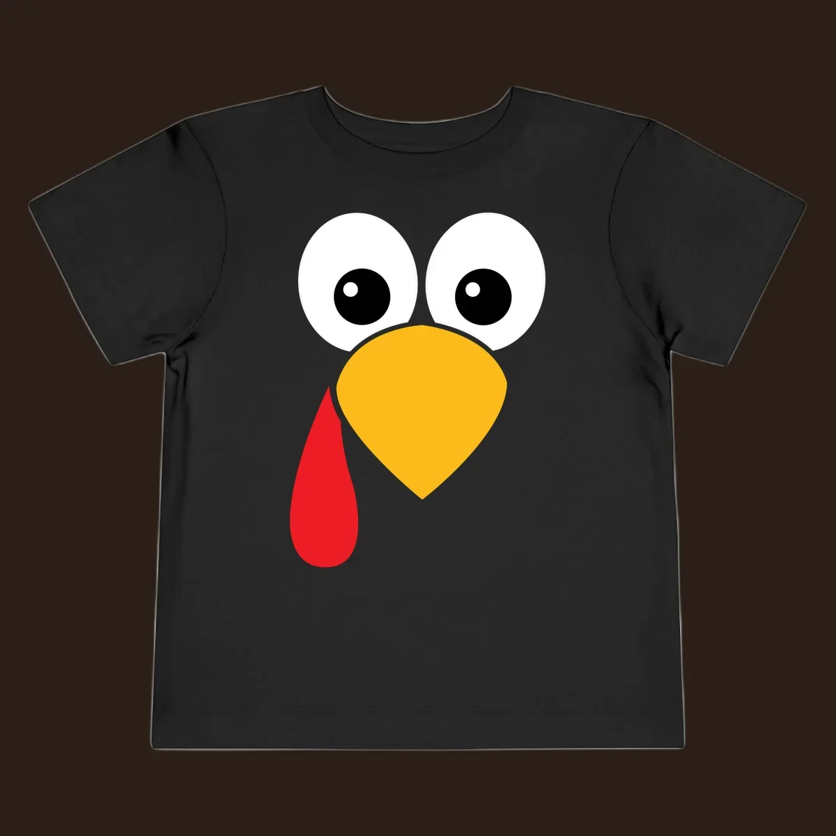 Funny turkey face illustration with big eyes, yellow beak, and red wattle for Thanksgiving.