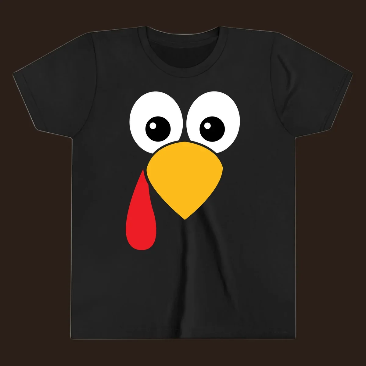 Funny turkey face illustration with big eyes, yellow beak, and red wattle for Thanksgiving.