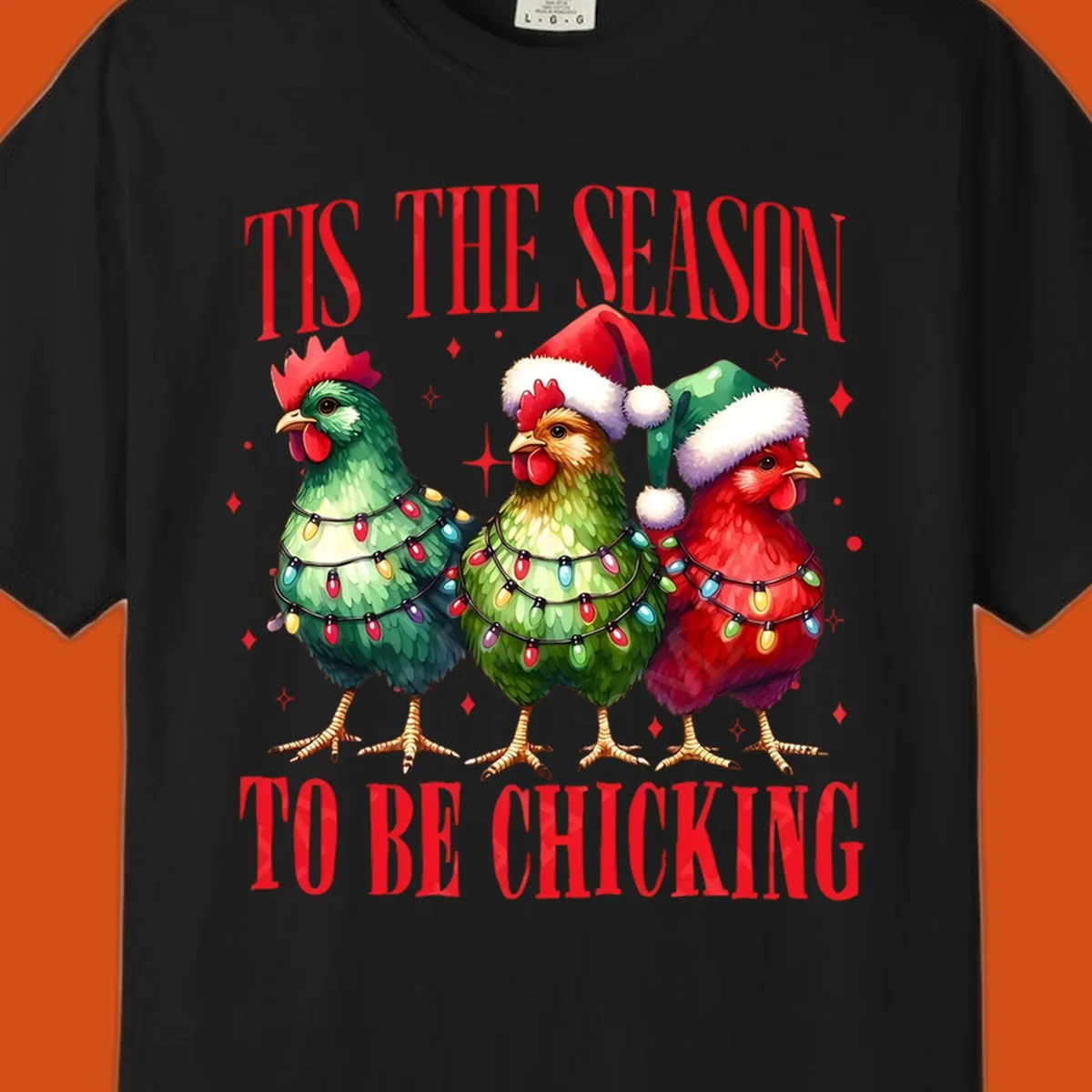 Christmas chickens wearing Santa hats and decorated with lights, with text 'Tis The Season To Be Chicking'.