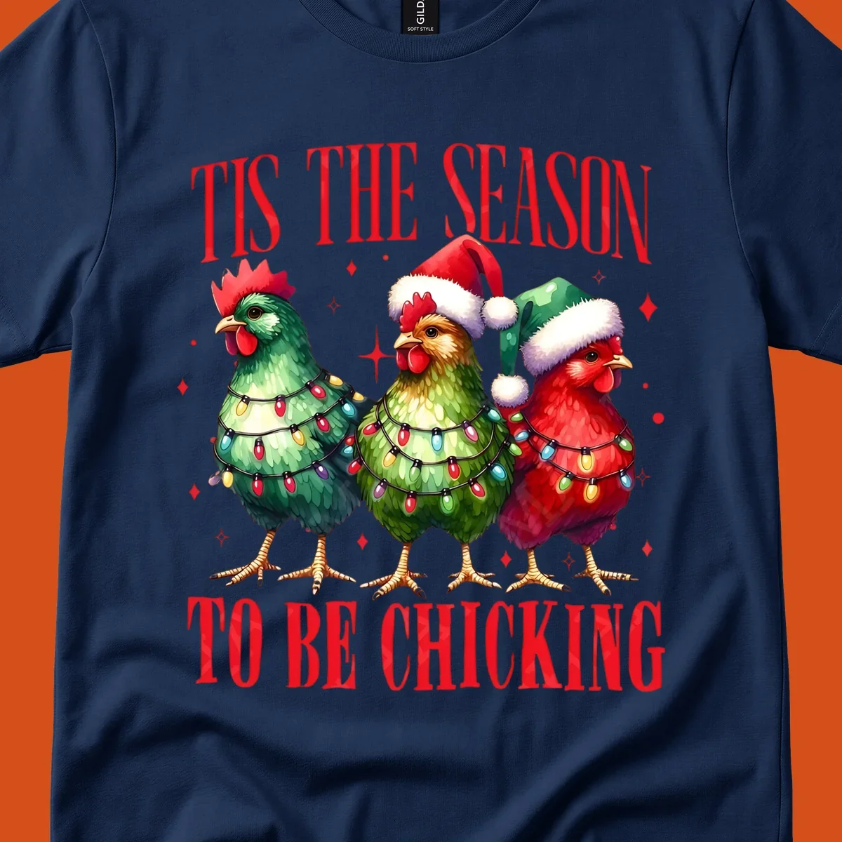 Christmas chickens wearing Santa hats and decorated with lights, with text 'Tis The Season To Be Chicking'.