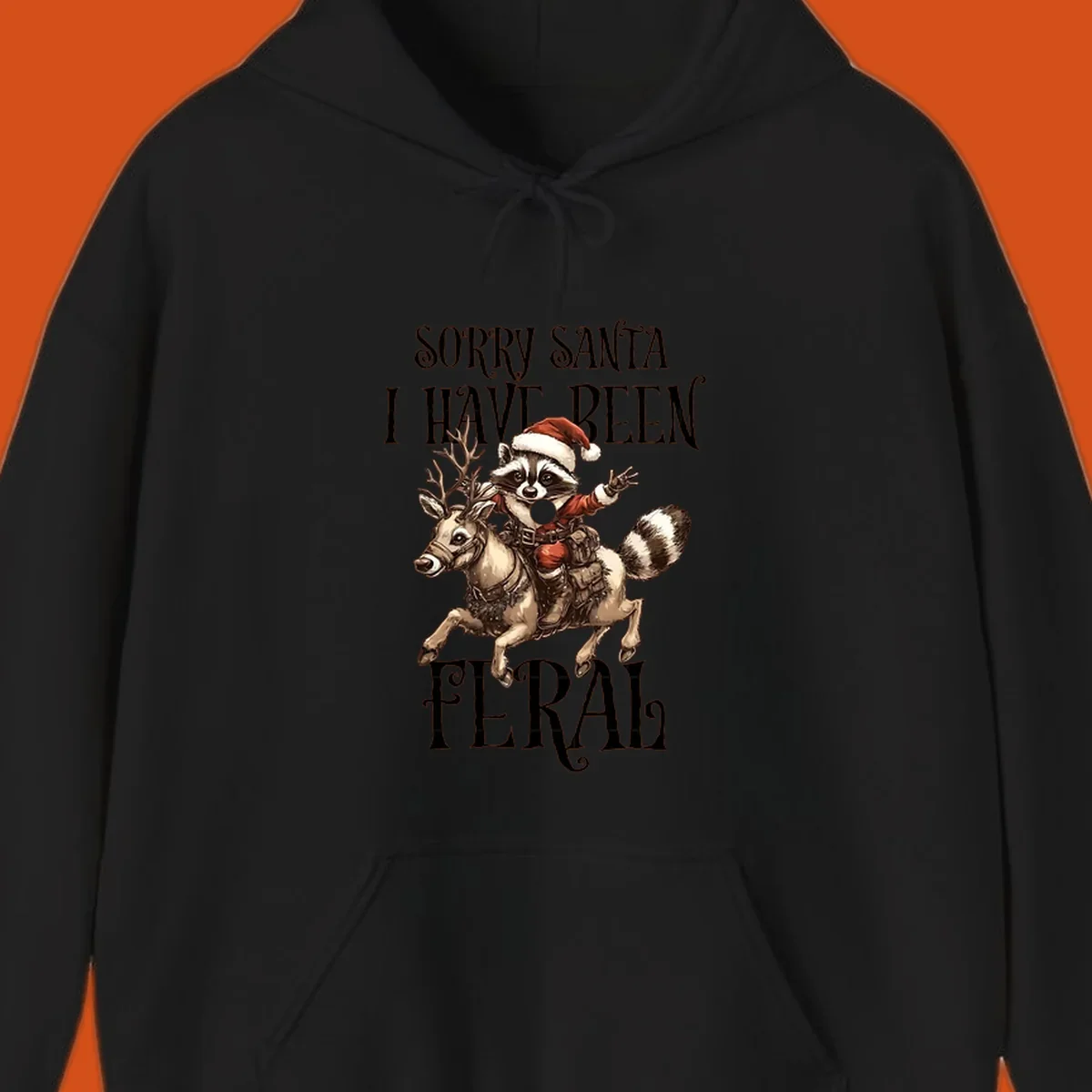 Feral raccoon in Santa hat riding reindeer, with text sorry santa i have been feral.