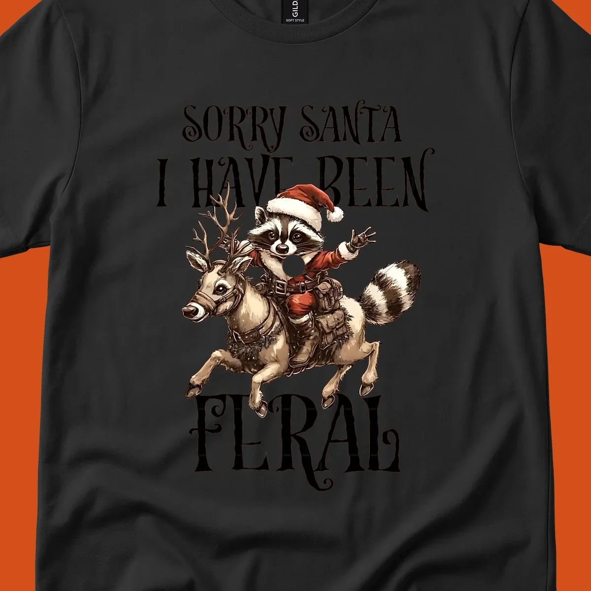 Feral raccoon in Santa hat riding reindeer, with text sorry santa i have been feral.