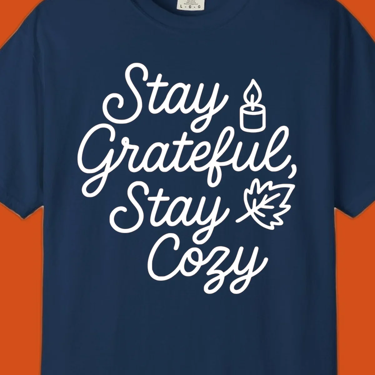 Text design with 'Stay Grateful, Stay Cozy' phrase, candle, and leaf for grateful-cozy-fall theme.