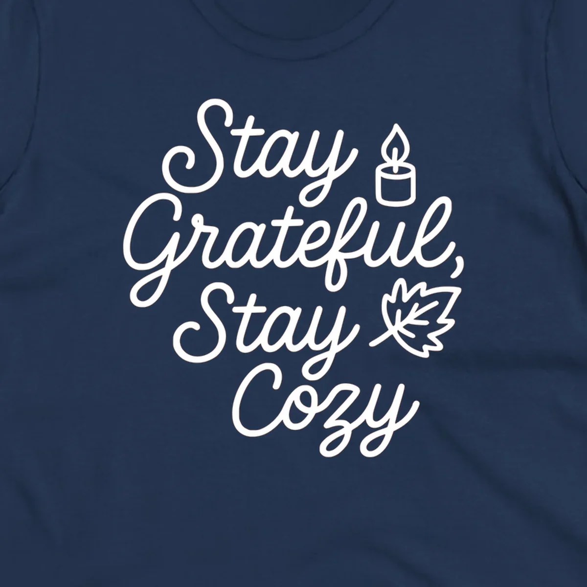 Text design with 'Stay Grateful, Stay Cozy' phrase, candle, and leaf for grateful-cozy-fall theme.