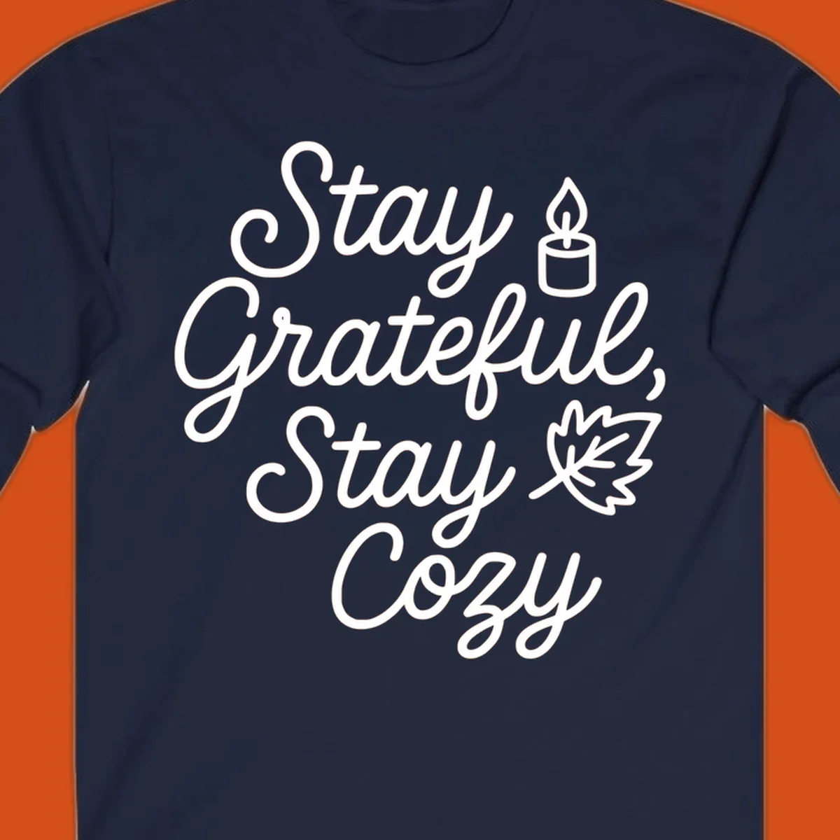 Text design with 'Stay Grateful, Stay Cozy' phrase, candle, and leaf for grateful-cozy-fall theme.