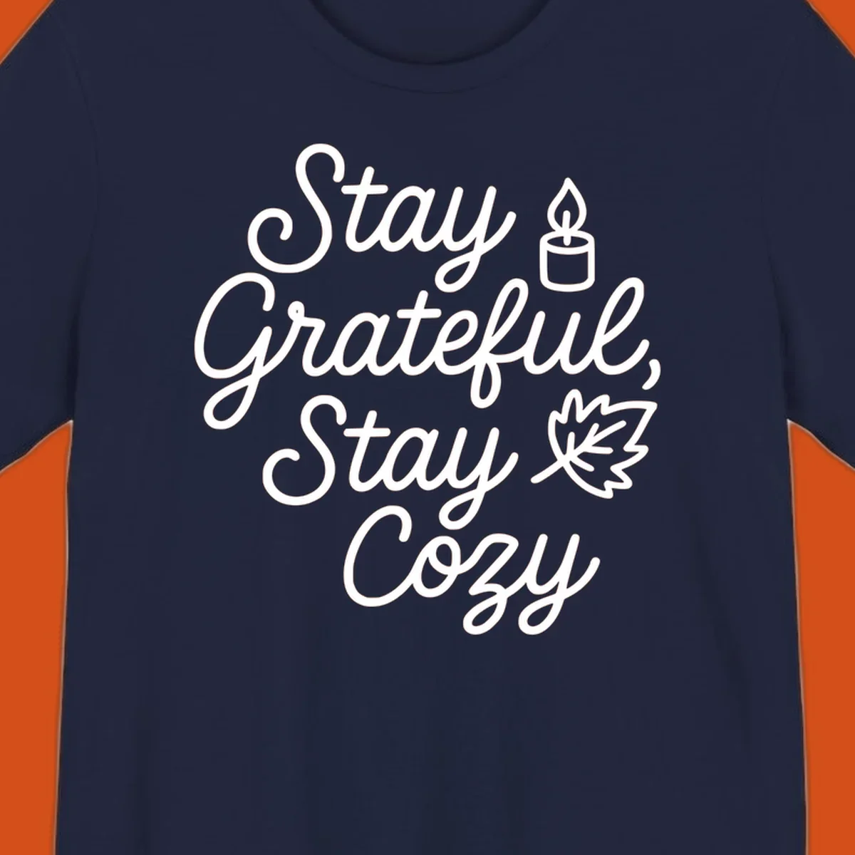 Text design with 'Stay Grateful, Stay Cozy' phrase, candle, and leaf for grateful-cozy-fall theme.