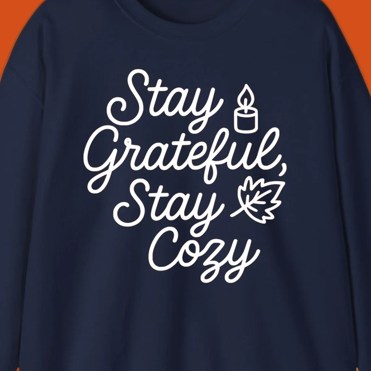 Text design with 'Stay Grateful, Stay Cozy' phrase, candle, and leaf for grateful-cozy-fall theme.