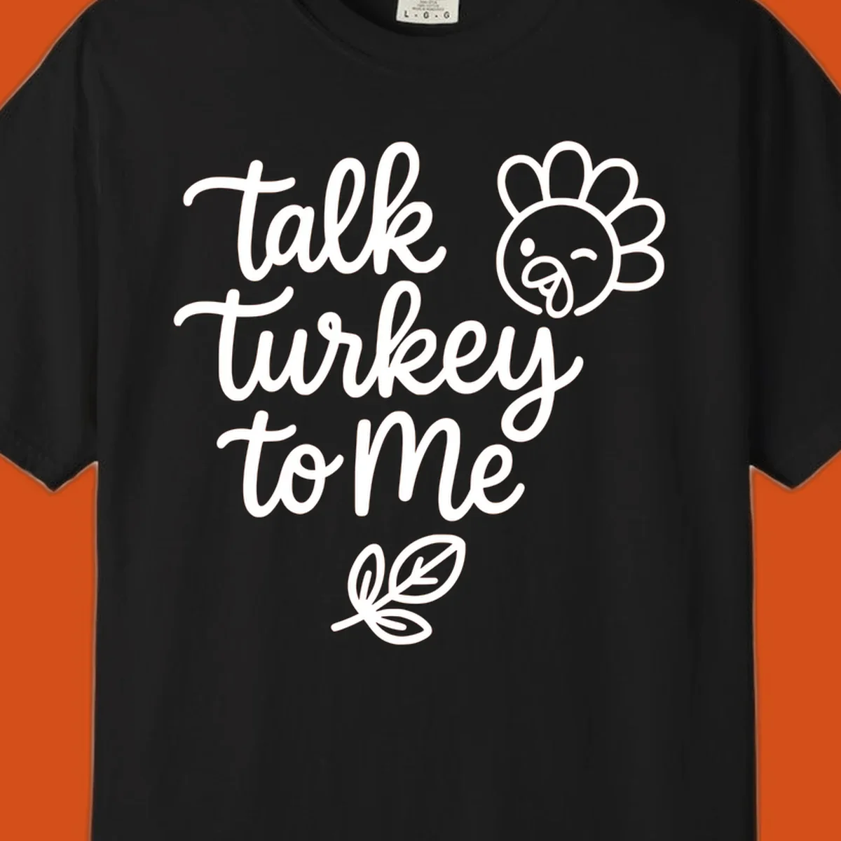 Talk Turkey To Me Thanksgiving phrase with cartoon turkey and leaf illustration.