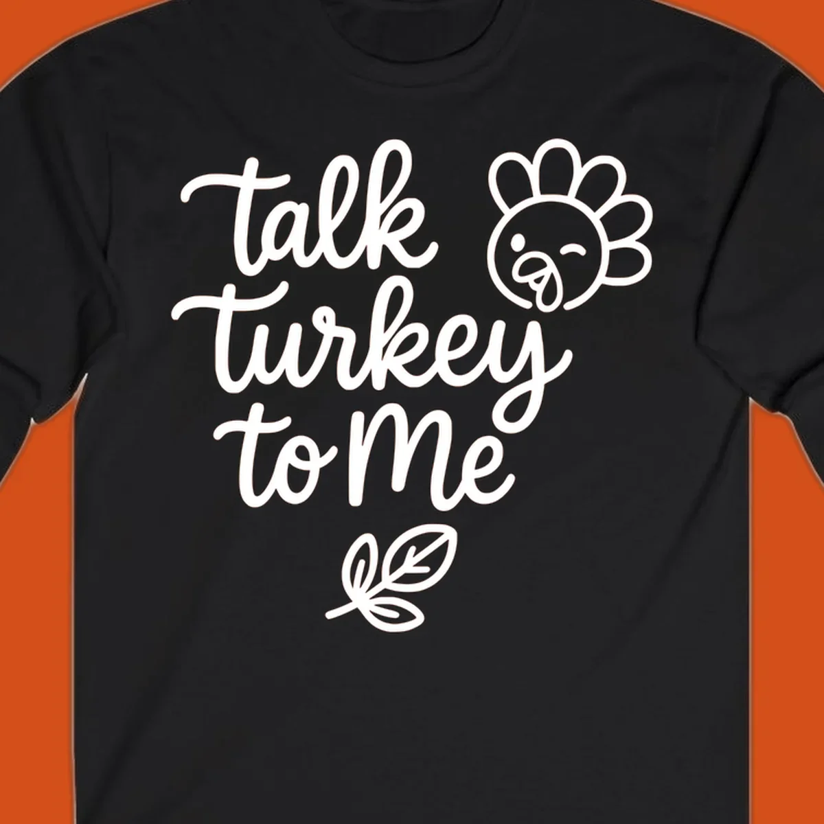 Talk Turkey To Me Thanksgiving phrase with cartoon turkey and leaf illustration.
